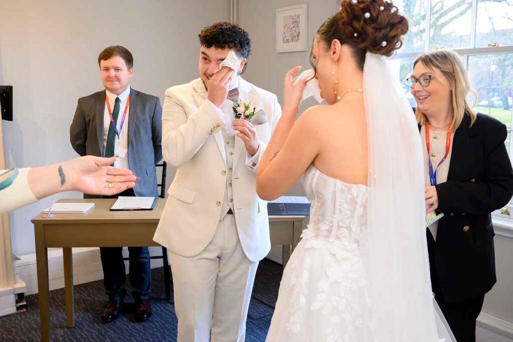 An emotional embrace between the bride and groom after